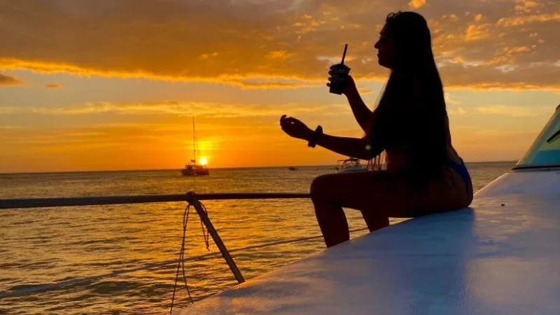 Mujer disfrutando en yate el atardecer en Punta del Este
